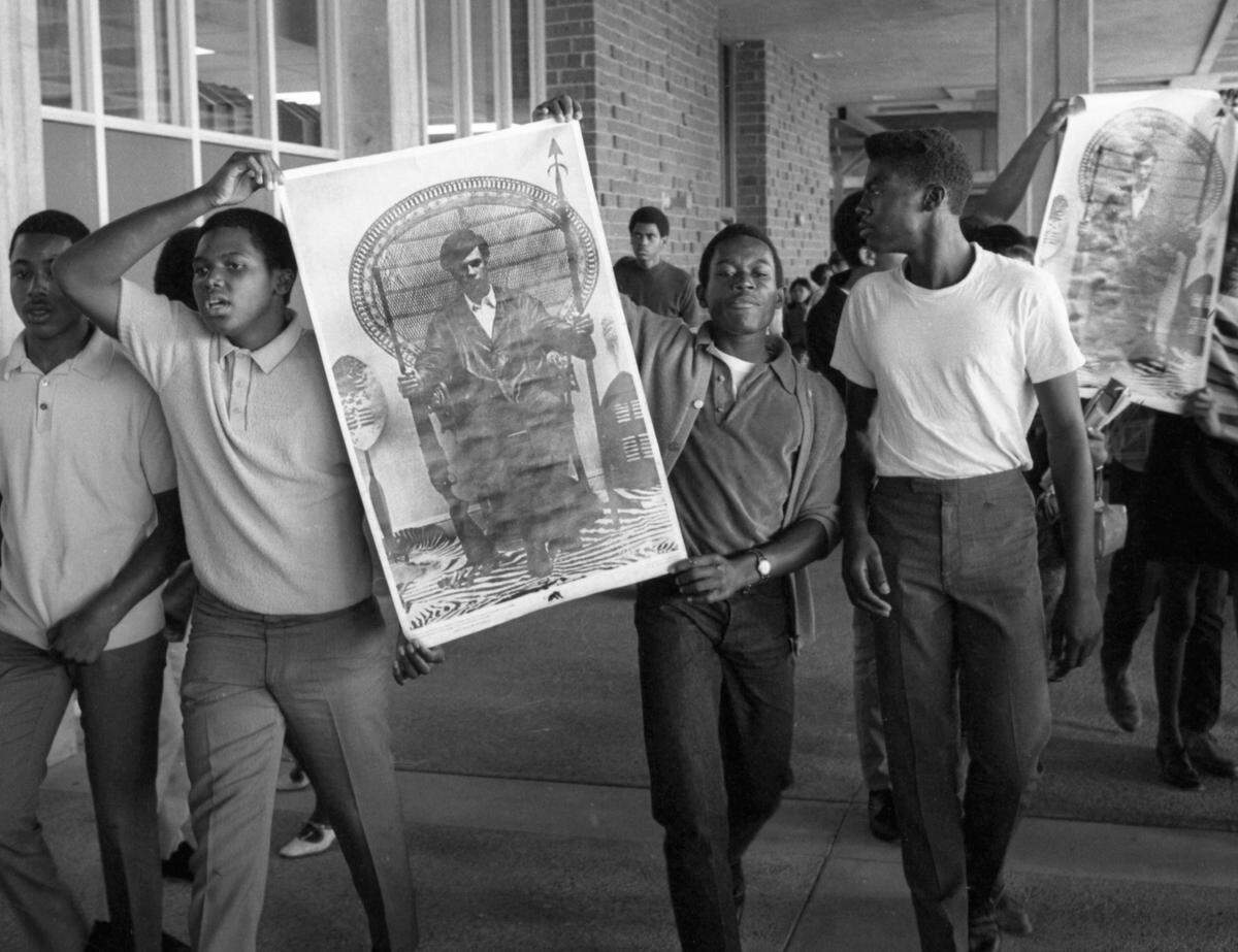 John F. Kennedy High School students hold a poster of Black Panther Huey Newton as they protest police response to a fight at their school on Oct. 2, 1968. About 40 black and white students got into a racially tinged brawl that day, and police arrested 16 students – 14 black, 2 white. The violence continued the next day when 10 white teens armed with clubs attacked several black students. All 10 were arrested.