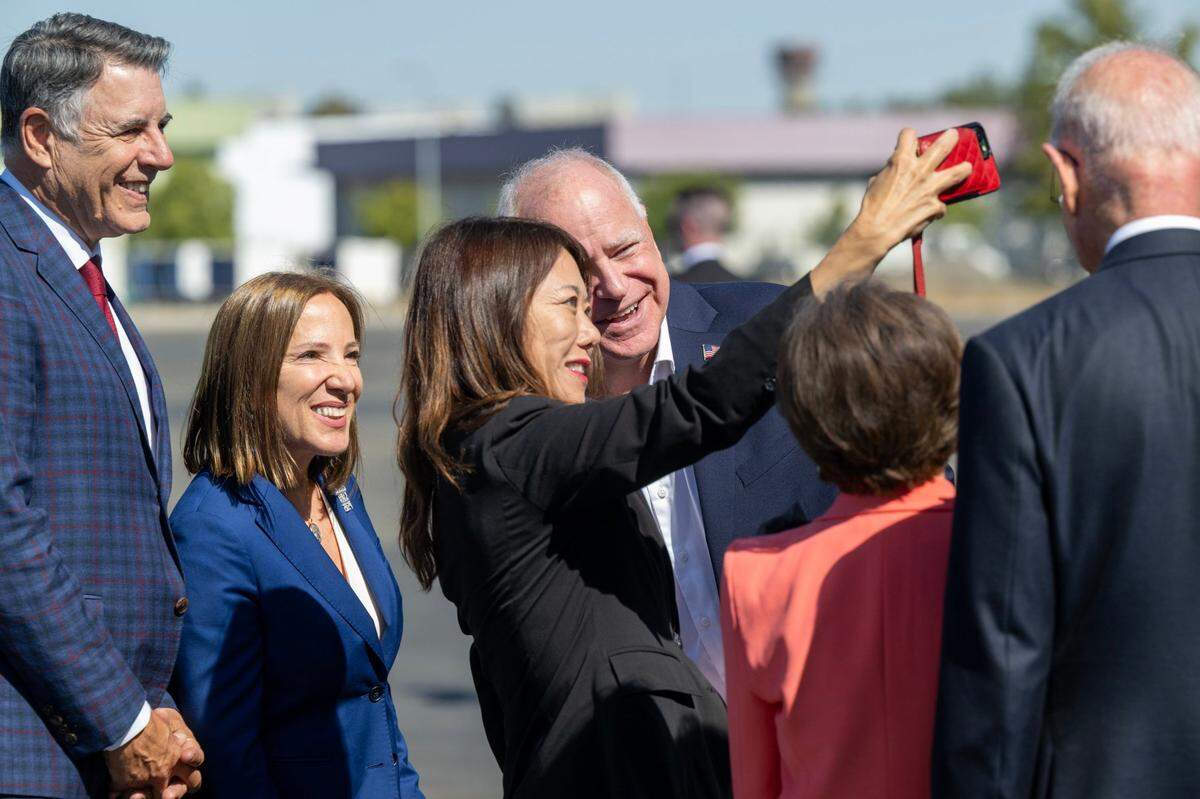 California Treasurer Fiona Ma takes a selfie with Democratic vice presidential candidate Tim Walz, governor of Minnesota, and Lt. Gov. Eleni Kounalakis and husband Markos Kounalakis during a stop to meet with donors on Tuesday at Sacramento International Airport.
