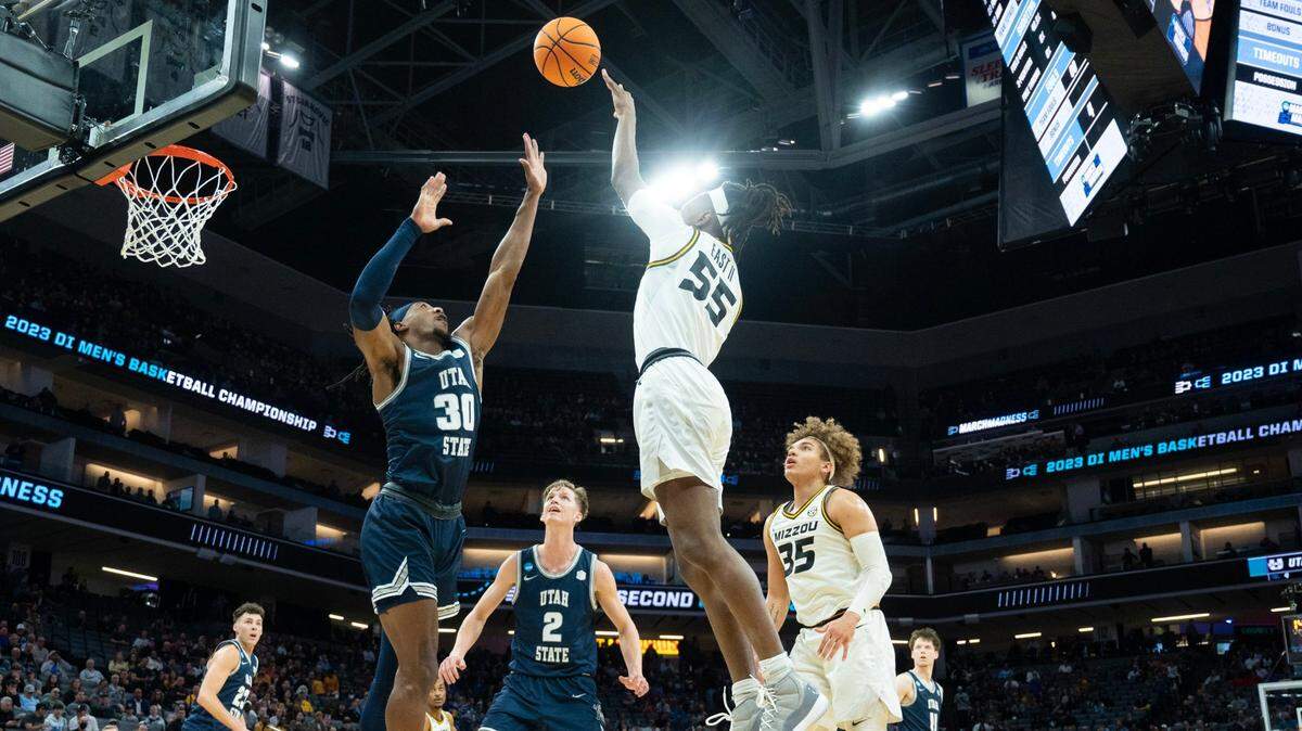 Missouri Tigers guard Sean East II (55) shoots over Utah State Aggies forward Dan Akin (30) during a first-round game in the NCAA Tournament at Golden 1 Center in Sacramento on Thursday, March 16, 2023.