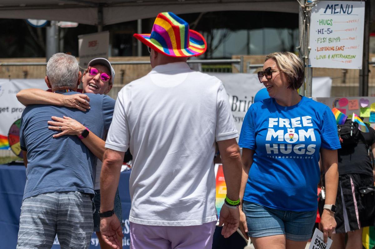 Two people hug at the Free Mom Hugs booth at the 33rd annual Sacramento Pride festival on Saturday, June 8, 2024.