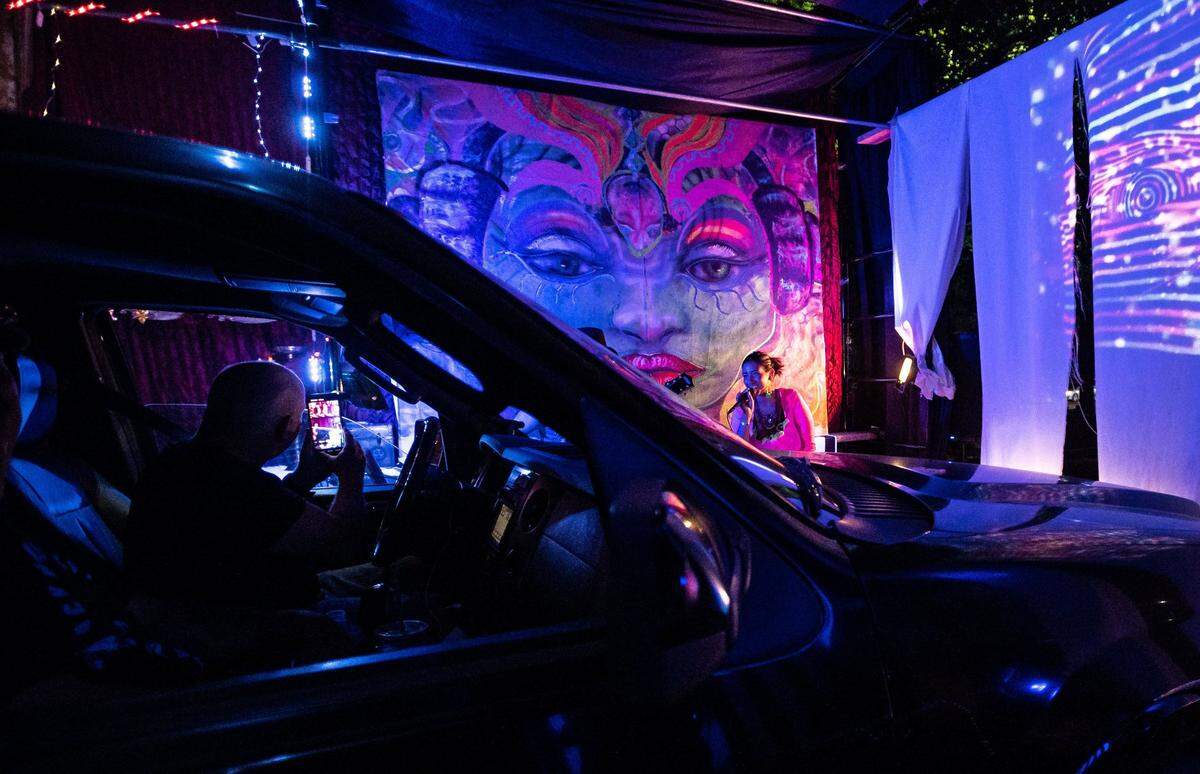 Eliza Maroney, center, of Sacramento, sings and interacts with viewers in the Sonic Brainwash, alongside her husband, Luke Maroney, Alexa Jesse and Sean Stillwell, during the Summer Spark drive-thru art event Friday, July 24, 2020, on Mine Shaft Lane in Rancho Cordova. The Burning Man festival-inspired event lasted two nights.