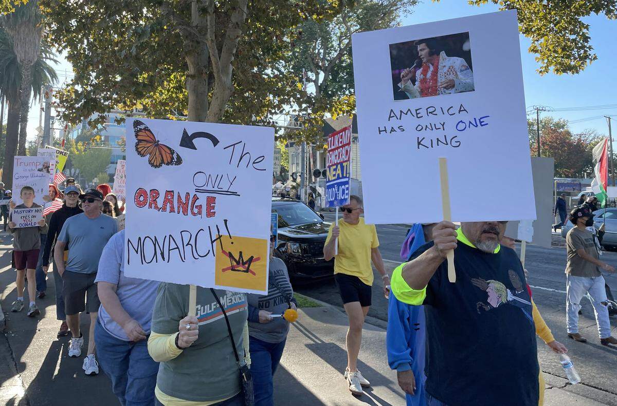 Protesters march on L Street on their way to the Capitol for the “No Kings” protest in Sacramento on Saturday. 