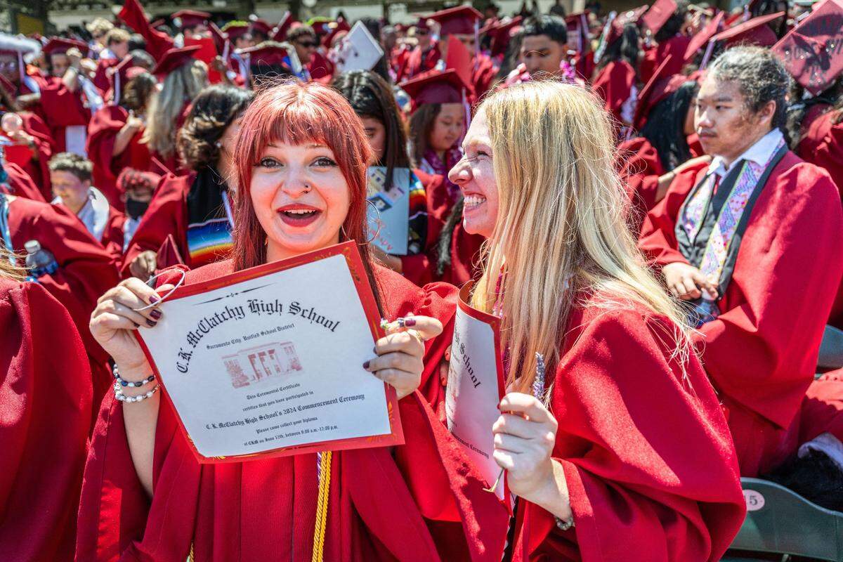Kennedy Rechs and Gwendolyn Seifert celebrate after graduating from C.K. McClatchy High School during their commencement ceremony on Tuesday at Sutter Heath Park in West Sacramento.