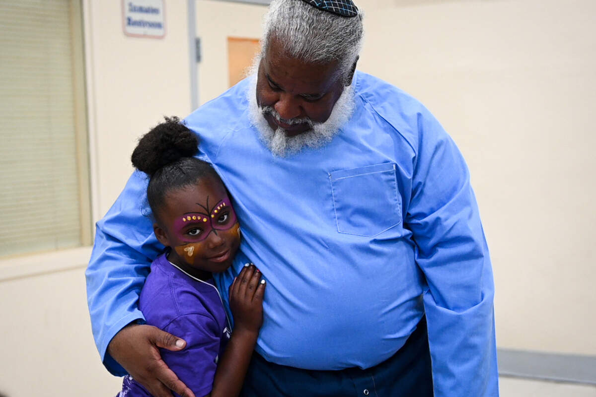 Kinney Compton hugs his granddaughter, Arianna Harris, 9, for the first time on Saturday, June 8, 2019 at Folsom State Prison in Folsom, California, as part of the “Get on the Bus” event, which allowed children from all over California to visit their incarcerated parents. 