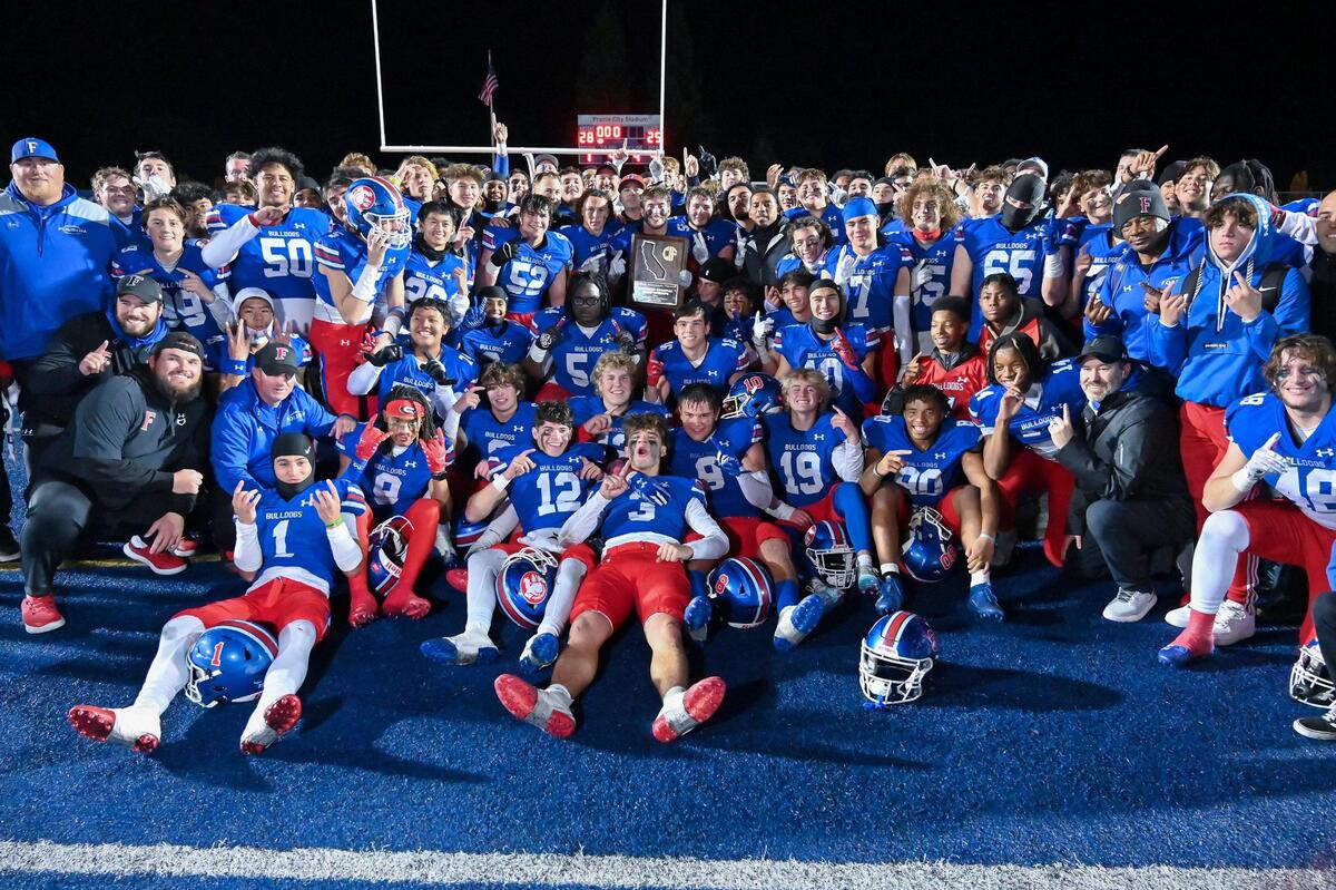 The Folsom Bulldogs pose for a photo with the championship plaque after winning the CIF Northern California Division 1-A championship against the Pittsburg Pirates on Saturday, Dec. 2, 2023, at Folsom High School.