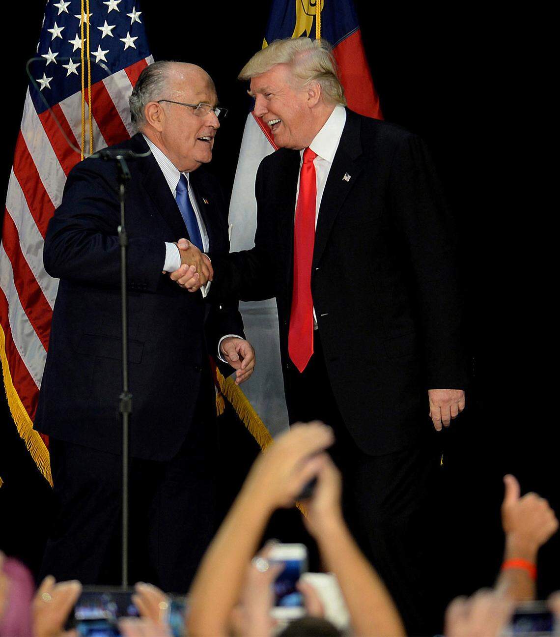 Former New York City mayor Rudy Giuliani, left, welcomes then-Republican presidential candidate Donald Trump on stage during a campaign rally on August 18, 2016, at the Charlotte Convention Center in Charlotte, N.C. (Jeff Siner/Charlotte Observer/TNS)