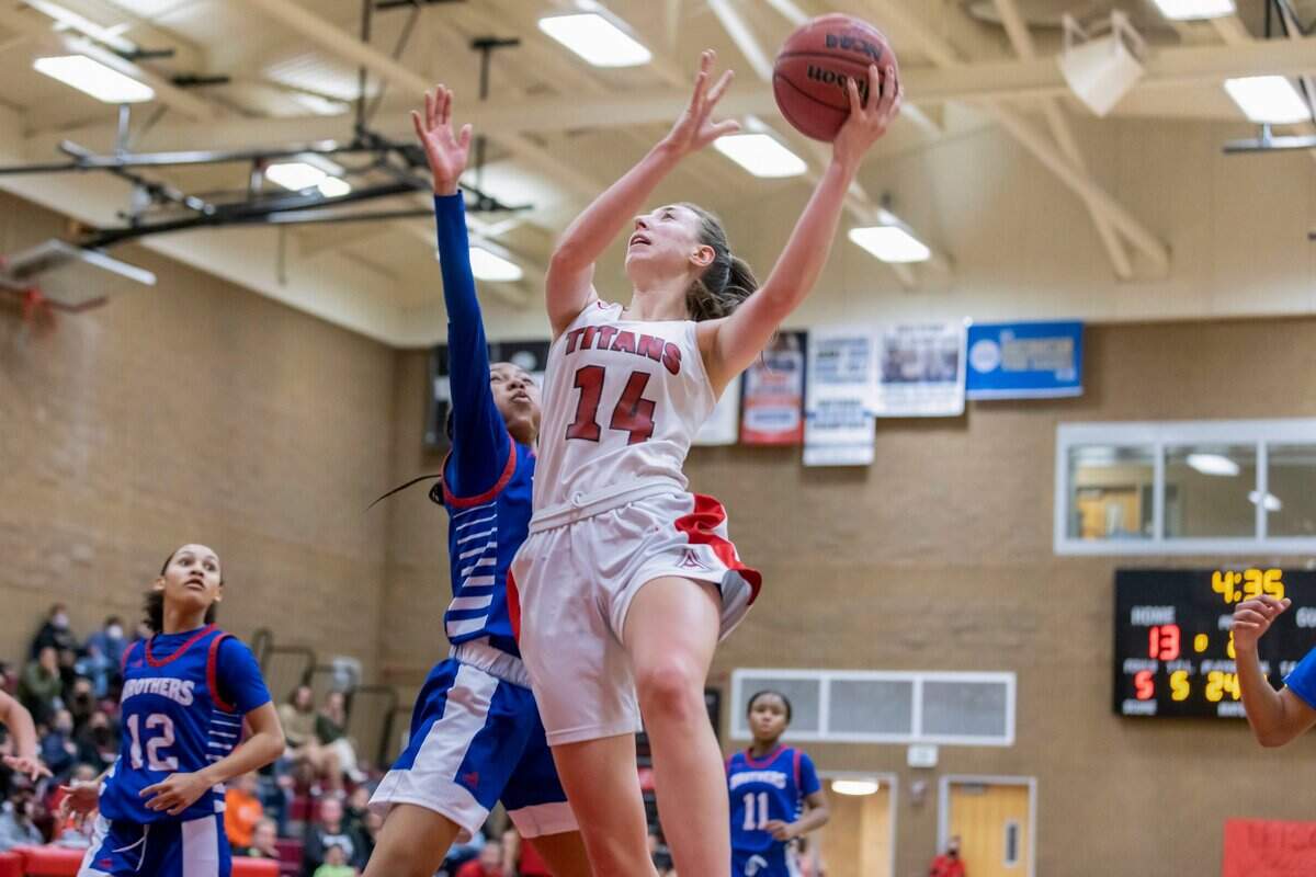 Antelope Titans forward Mary Carter (14) shoots a layup over the Christian Brothers Falcons Jene Wells (1) during the second quarter at the Sac-Joaquin Section Division II quarterfinals at Antelope High School. Carter was the top scorer with 24 points and eight rebounds. The Titans won 56-36.