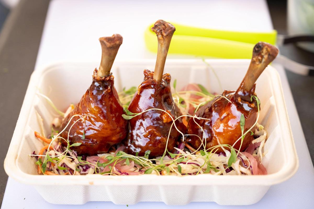Smoked peach chipotle chicken lollipops wait to be served at the pop-up Flora & Fauna Provisions outside Nitty’s Cider in July.