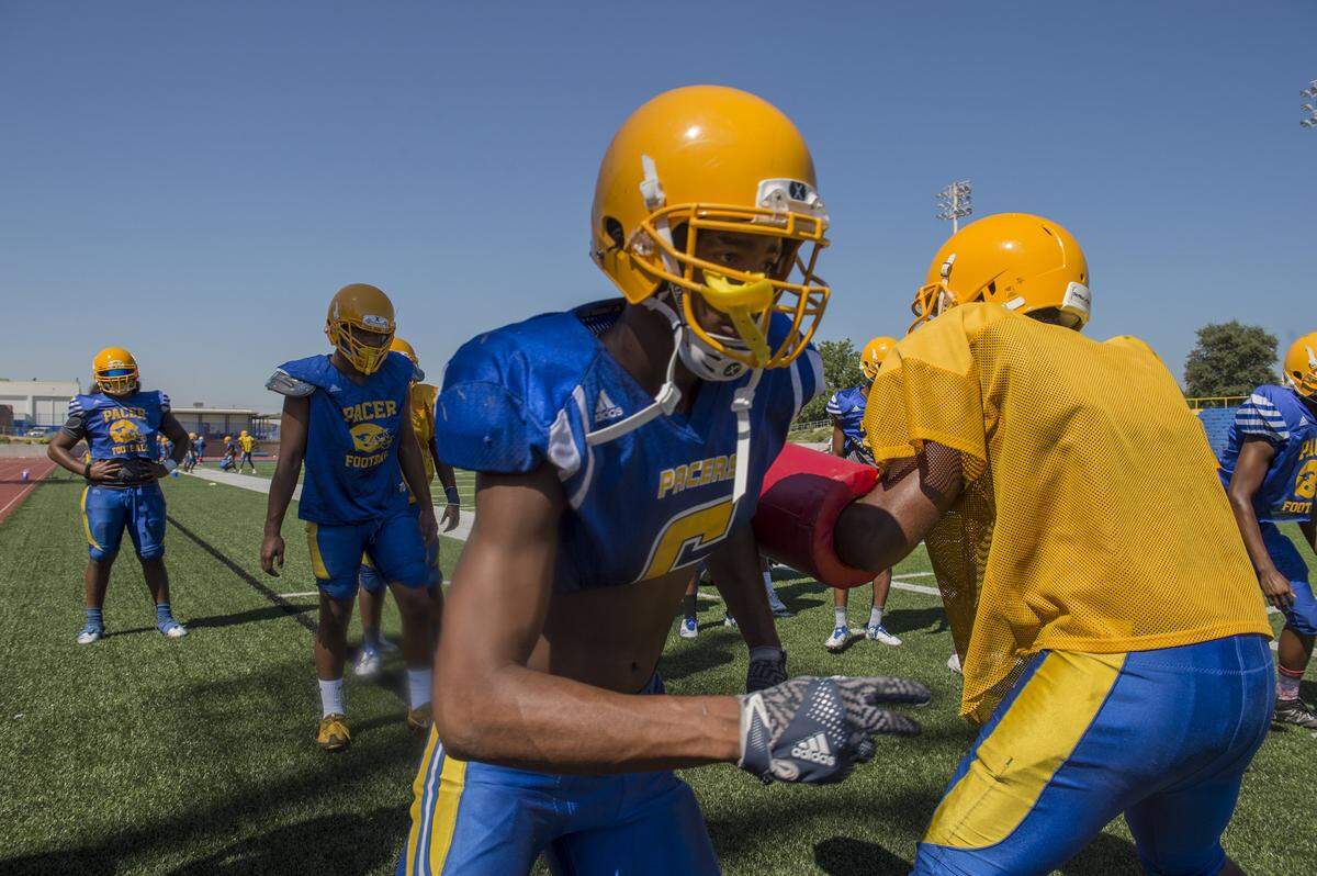 Grant High School’s Paris Warren runs through blocking drills on the first day of practice on Aug. 7, 2017, in Del Paso Heights.