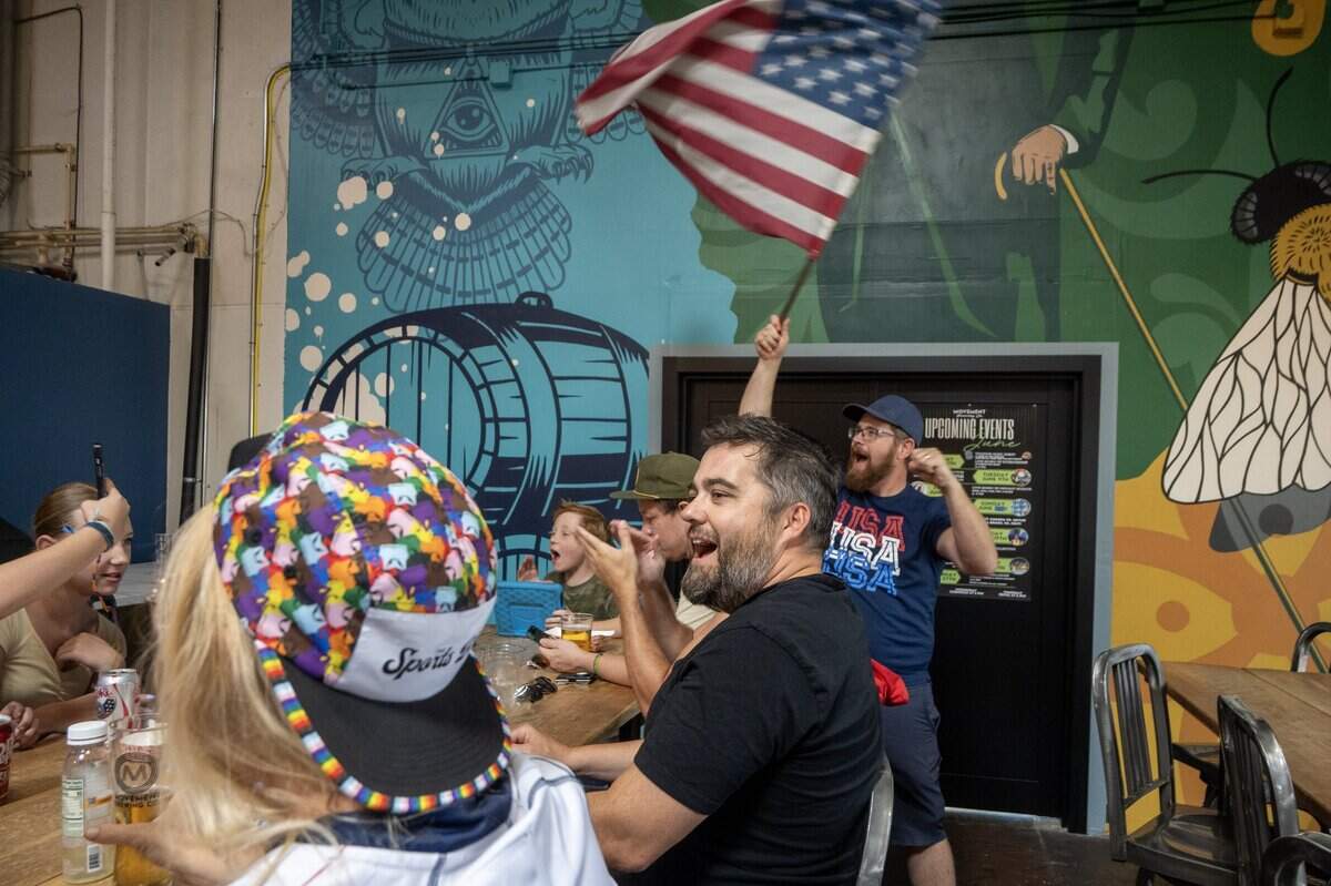 Chris Cornish waves an American flag after watching the U.S. men's national soccer team defeat Australia in a World Cup match during a watch party at Movement Brewery on Friday, June 19, 2026, in Rancho Cordova.