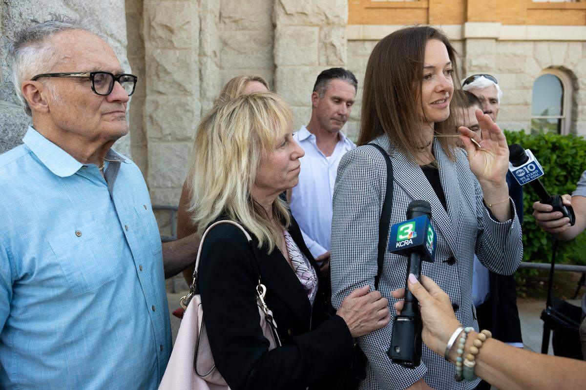 Adrienne Spohr, the victims’ daughter, holds a locket containing her father’s ashes and wears her mothers engagement ring as she talks to the media on Monday, July 14, 2025, after Daniel Serafini was found guilty in Placer Superior Court of murdering his in-laws.