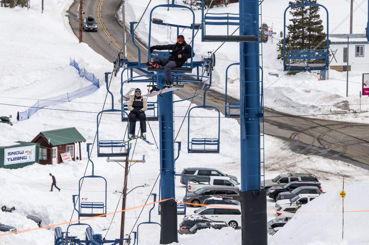 Felipe Mitre, right, takes a ride on a lift at Donner Ski Ranch earlier this month.