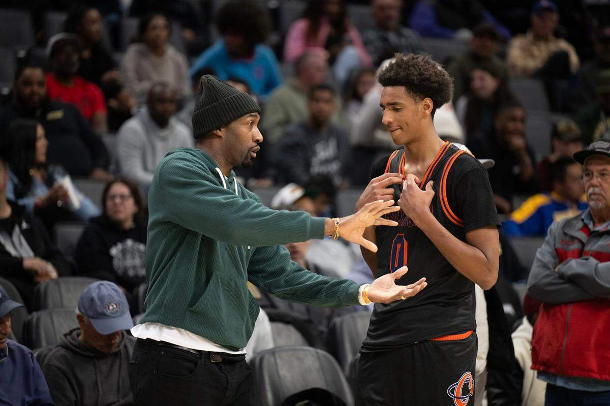 The Chatsworth Chancellors’ Alijah Arenas (0) gets instruction from his father, former NBA player Gilbert Arenas, before the second half against the Jesuit Marauders in CIF State Division II boys basketball final Saturday at Golden 1 Center.