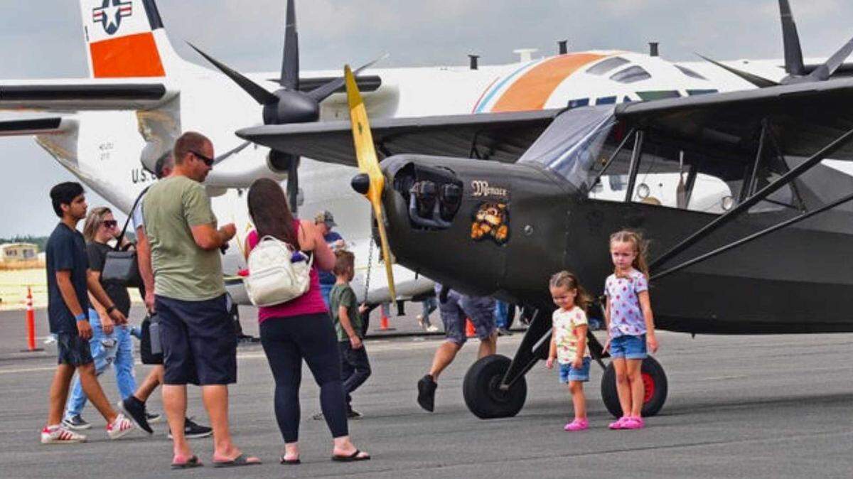 A family takes a photo in front of a small aircraft at Lincoln Regional Airport last year during the city’s annual Wings & Wheels event. The weekend exhibition features more than 60 aircraft, including military helicopters and vintage planes, along with hot air balloons, classic cars and youth aviation activities.
