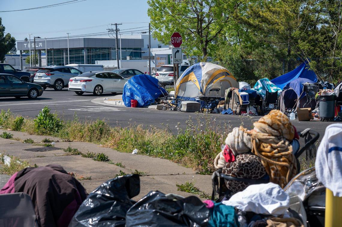 Tents line the sidewalk of Cooper Way, a residential street off Fulton Avenue in Arden Arcade in April 2021. Gov. Gavin Newsom wants to create a system of mental health CARE Courts that he says would help homeless people suffering from untreated schizophrenia or pyschosis.