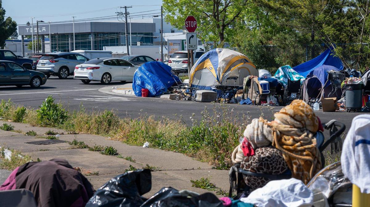Tents line the sidewalk of Cooper Way, a residential street off Fulton Avenue in Arden Arcade in 2021. 