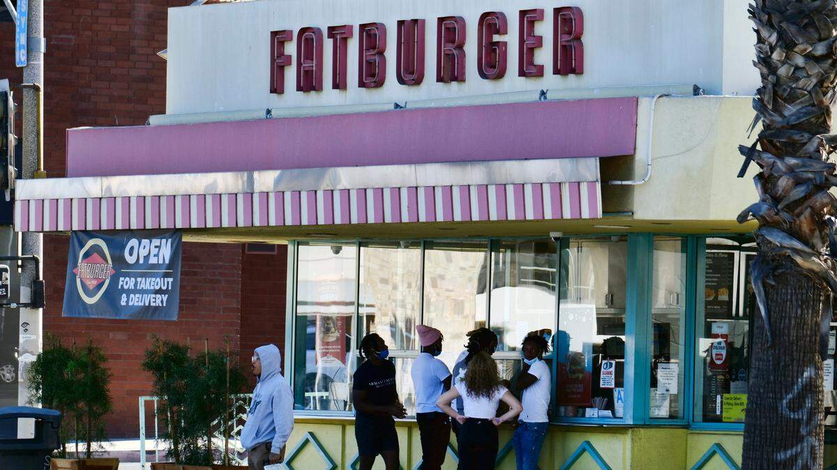 Customers wait for their order at Fatburger in the Sherman Oaks section of Los Angeles on Dec. 6, 2020. The Southern California-based hamburger chain is coming to Elk Grove, making it the fourth restaurant in Northern California.