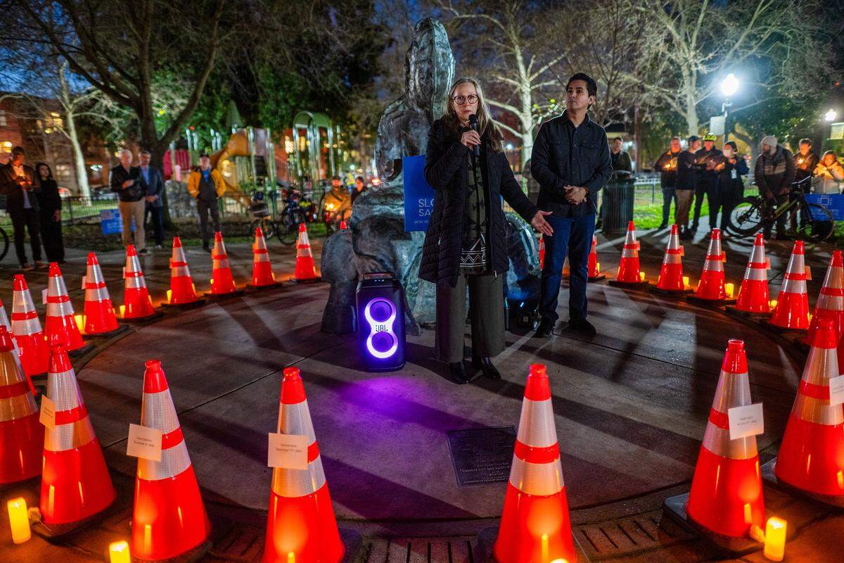 Michelle Silva speaks about the loss of her husband as she stands in front of a circle of cones representing people killed in Sacramento in 2025 by fatal vehicle crashes during a vigil on Wednesday at Fremont Park. Her husband, José Luis Silva, was struck by a truck while riding his motorcycle in midtown. “I’m still trying to figure out life without him, and like you, my family is devastated,” Silva said.