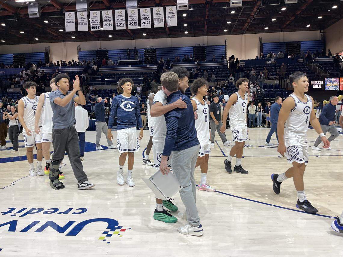 UC Davis men’s basketball players celebrate their 77-73 win over Sacramento State on Friday at the University Credit Union Center on the UC Davis campus.