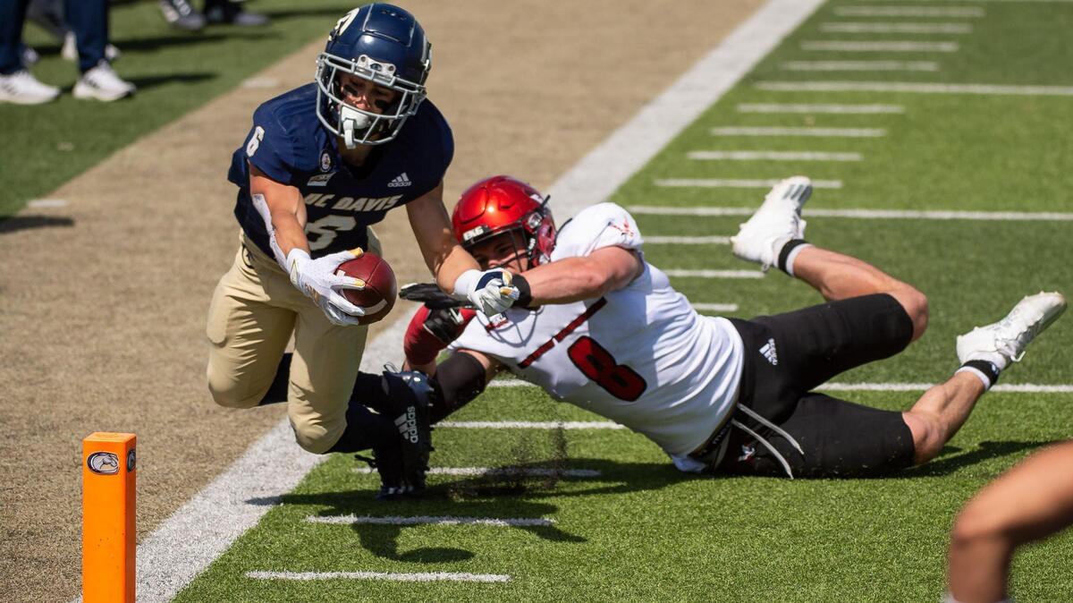 UC Davis Aggies wide receiver Carson Crawford (6) brings the ball to the one yard line, just short of a touchdown, as Eastern Washington Eagles linebacker Jack Sendelbach (8) brings him down during the first quarter of the college football game Saturday, April 3, 2021, at UC Davis Health Stadium. The Aggies were not able to score in the first half.