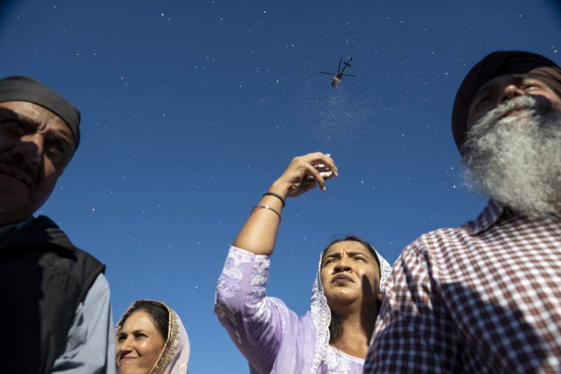 Rose petals are dropped from a helicopter before the start of Nagar Kirtan, also known as the Sikh Parade, in Sutter County on Sunday, Nov. 2, 2025.