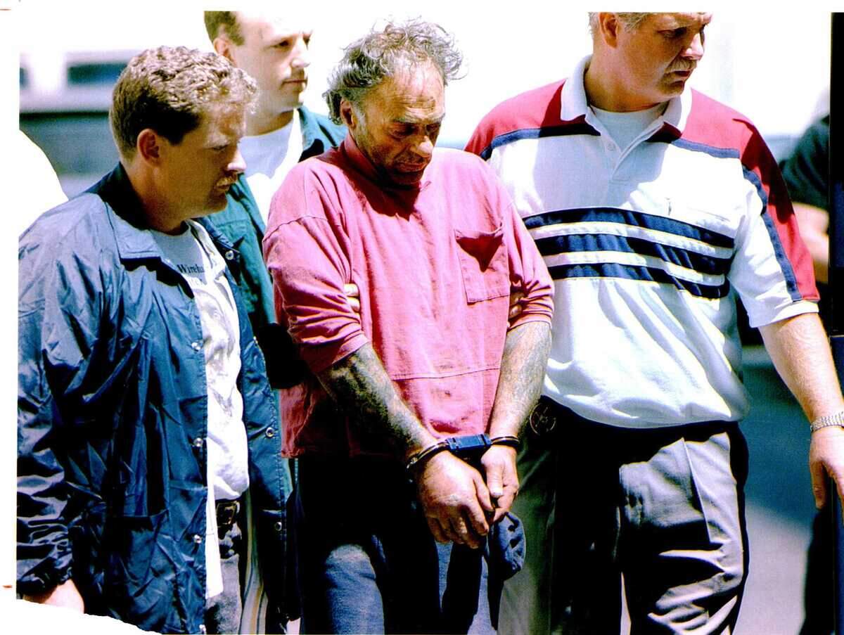 Gerard Joseph Gallant Jr., center, is escorted by authorities outside Sacramento federal court in 1993 after he was sought for the shooting of Sacramento County sheriff’s deputy Steven Fonbuena in an ambush that freed federal prisoner Victor F. Carrafa. Carrafa was captured Thursday in Stockton.