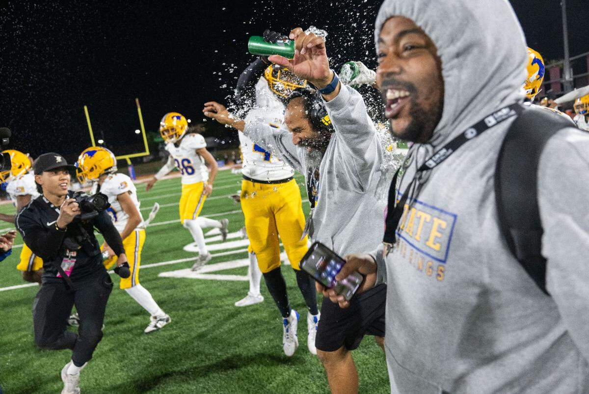 Grant Pacers coach Carl Reed gets doused with water after his team’s 35-28 victory against the Pacifica Tritons for the CIF State Division 2-AA championship at Saddleback College in Mission Viejo on Friday, Dec. 13, 2024.
