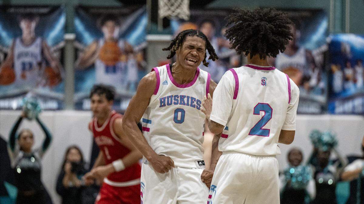 The Sheldon Huskies' David Williams (0) celebrates with teammate Teyjaun Carter (2) after a made basket in the second half of a CIF Sac-Joaquin Section Division I semifinal game against the Folsom Bulldogs on Tuesday in Vineyard.