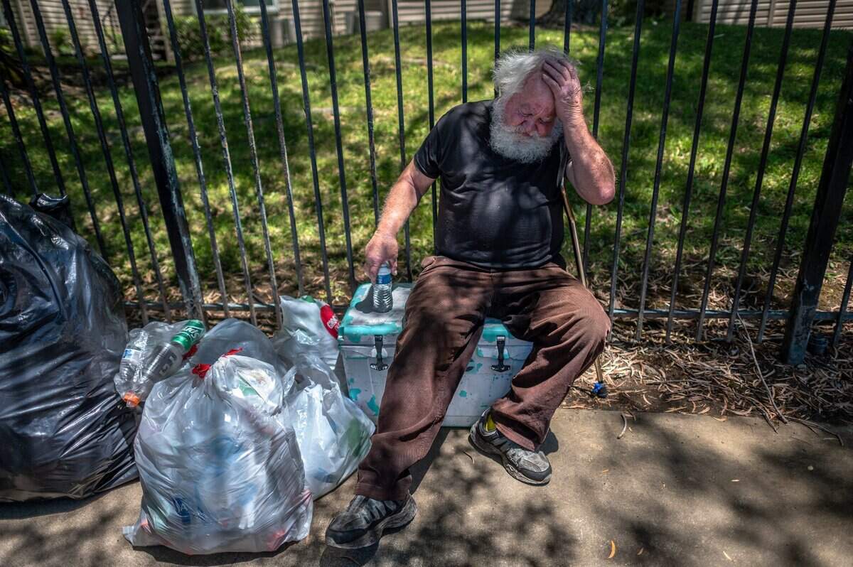 Donald Lowery, 73, rests on an ice chest he uses to store his medications on Hamilton Street on Monday June 14, 2021, in Sacramento. He has been homeless since Friday when he returned from the hospital and was shut out of his room at the Comfort Inn and Suites in Rancho Cordova. He is one of about 250 people that have been kicked out of the three Project Roomkey motels in Sacramento. It’s a state program that Sacramento County administers.