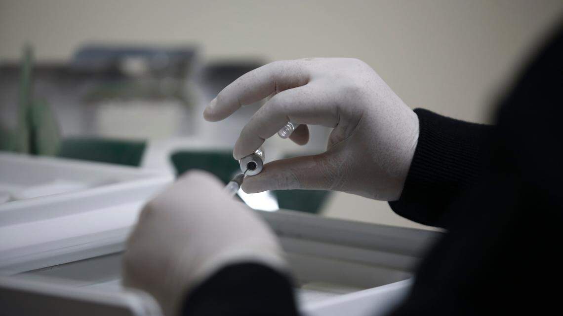 A nurse prepares a shot of the Pfizer vaccine against COVID-19, on the first day of coronavirus vaccinations in Ciudad Juarez, Mexico, Wednesday, Jan. 13, 2021. (AP Photo/Christian Chavez)