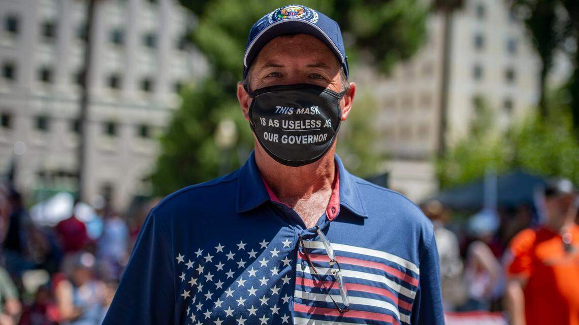 “This mask is as useless as our governor,” reads the mask worn by Doug Marjama of Sacramento at state Capitol on Saturday, Aug. 1, 2020, during a #WalkAway Campaign rally.