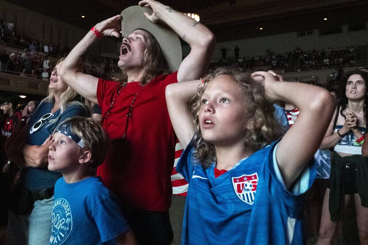 John Desilva and his sons John Paul Desilva and Roland Desvila react during a watch party at Memorial Auditorium in Sacramento on Wednesday as they watch the U.S. men's soccer team face off against Bosnia and Herzegovina in the World Cup. The game, which the U.S. won 2-0, was played in Santa Clara.