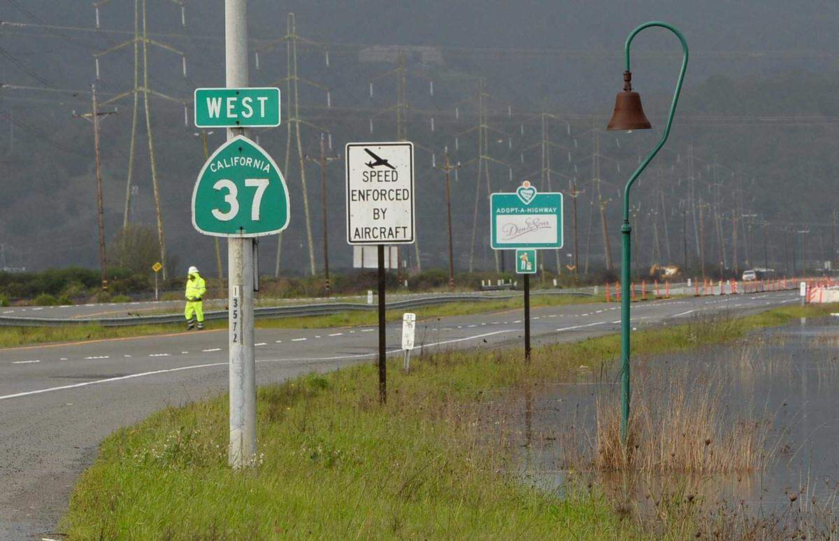 Water stands near the shoulder of Highway 37 in Novato after a storm on Wednesday, Feb. 27, 2019. A section of the road was closed due to flooding. Caltrans' current plan would not elevate the highway enough to prevent future flood closures, which experts warn will become more common due to climate change and levee failure.