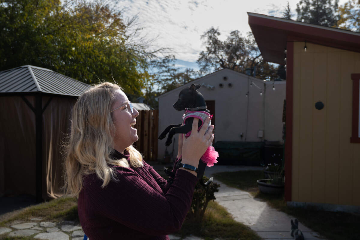 Kristi Schall embraces Chiquitita, a black Chihuahua ready for adoption at her small boutique rescue on Wednesday, Nov. 30, in Carmichael. Good Sense Dogs Rescue can only accommodate small and medium dogs and cats. She is asking for $13,000 to add a stand-alone building with heating and air conditioning, along with dog beds and a dog run.