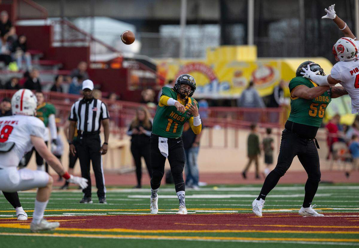 Law Hogs quarterback Jace Sloan throws downfield against the Fire Dogs in the 50th Pig Bowl on Saturday at Hughes Stadium. Sloan was one of the game’s MVPs.