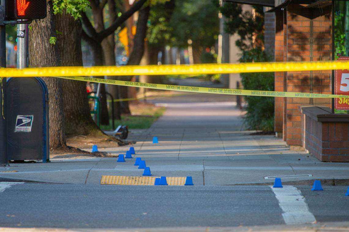 Evidence markers are seen on 16th and K streets in downtown Sacramento following a shooting with “multiple” victims on Monday.