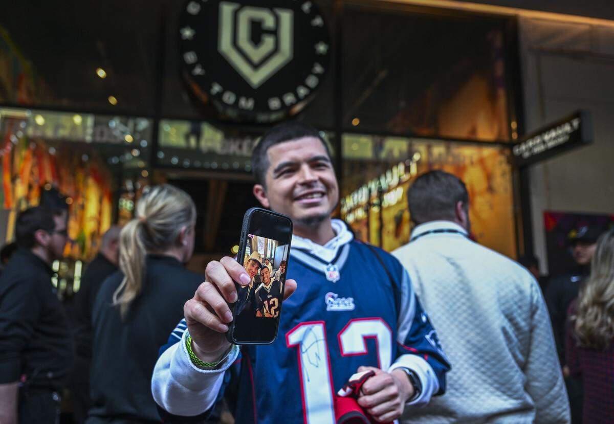 Cristhian Guillen, of Sacramento, was the first person in line at 7 a.m. to see the newly opened CardVault by Tom Brady store in DoCo’s West Plaza on Thursday. Guillen took a photo with his idol and had Patriots and Buccaneers jerseys signed. 