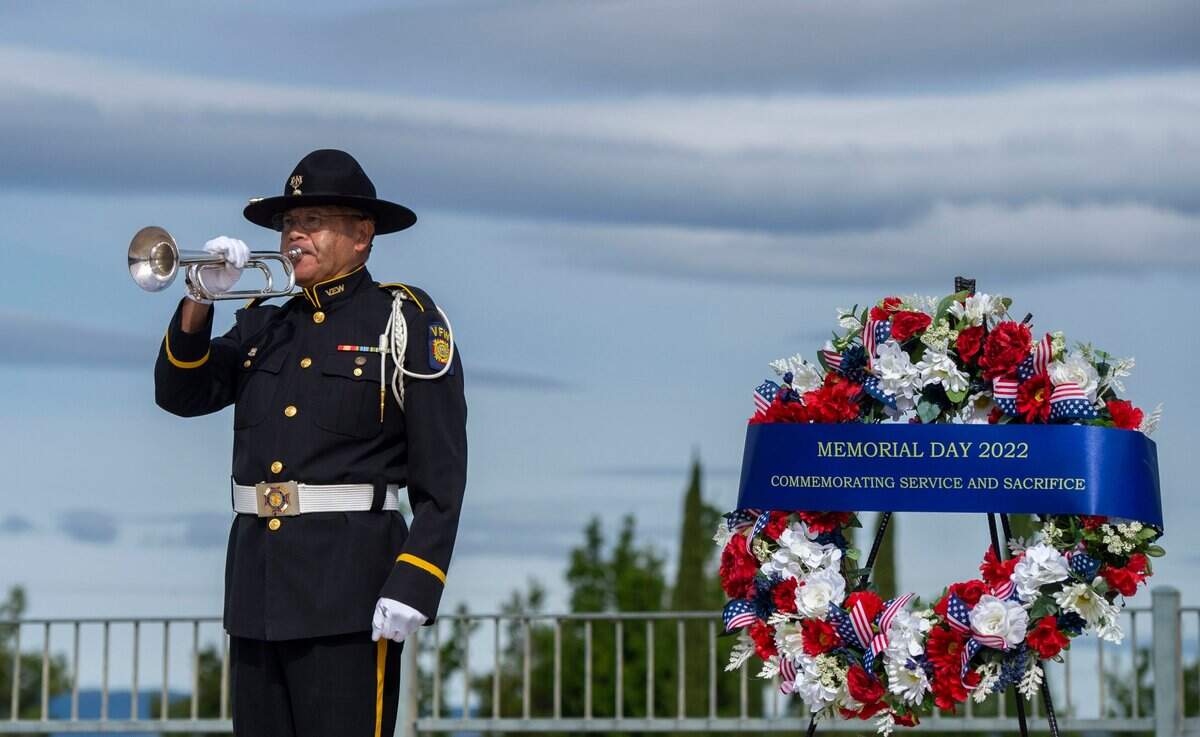 Veterans of Foreign Wars state bugler Baldwin Wong, with the Service Veterans of Northern California, plays taps following a wreath presentation during a Memorial Day ceremony at the Sacramento Valley National Cemetery in Dixon on Saturday.