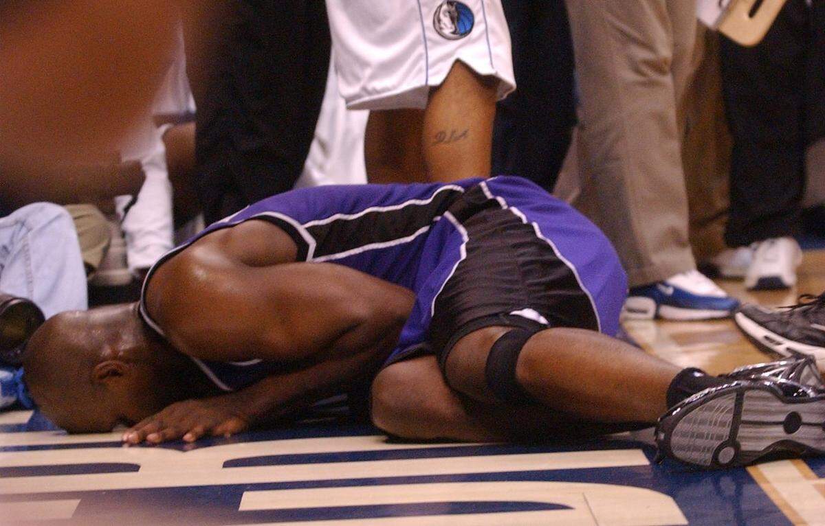 The Sacramento Kings' Chris Webber lies on the floor in the third quarter of Game 2 of the Western Conference Semifinals between the Sacramento Kings and the Dallas Mavericks at the American Airlines Center in Dallas on May 8, 2003. He underwent microfracture surgery to treat the serious injury to his knee.