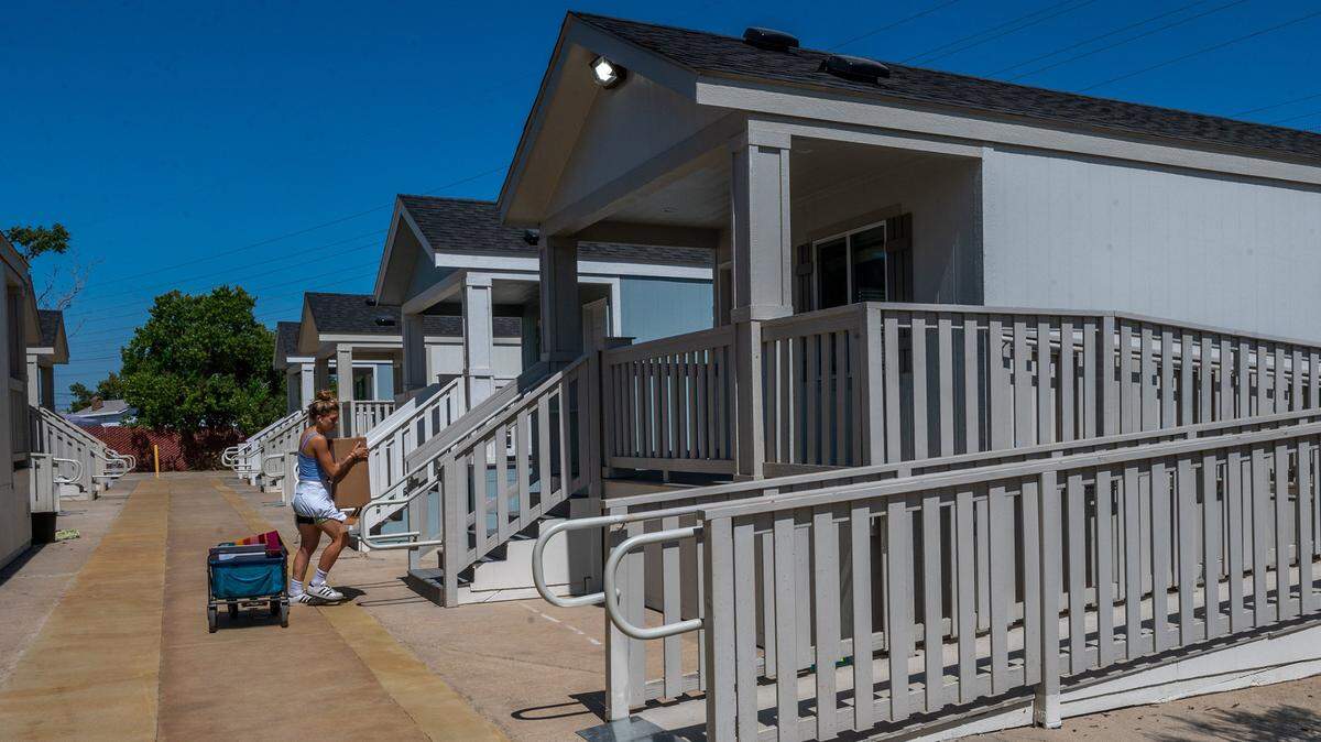 A volunteer in 2021 helps ready a new affordable modular housing community in Sacramento. 