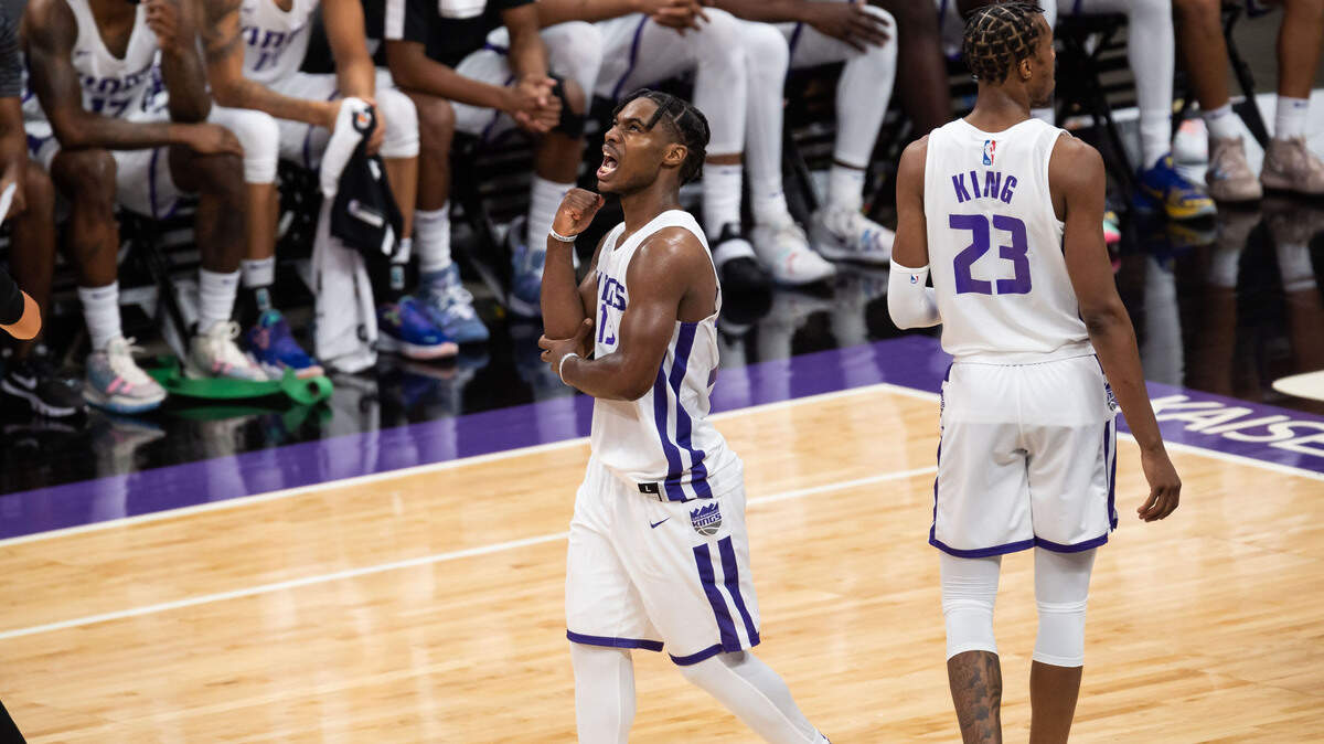 Sacramento Kings guard Davion Mitchell (15) holds his elbow after being fouled by Golden State Warriors guard Scottie Lindsey (28) during the fourth period of their NBA California Classic game Tuesday, Aug. 3, 2021, at Golden 1 Center in downtown Sacramento. The four-team, two-day format began Tuesday, featuring a double-header matchup each day with the Kings, Golden State Warriors, Los Angeles Lakers and Miami Heat.