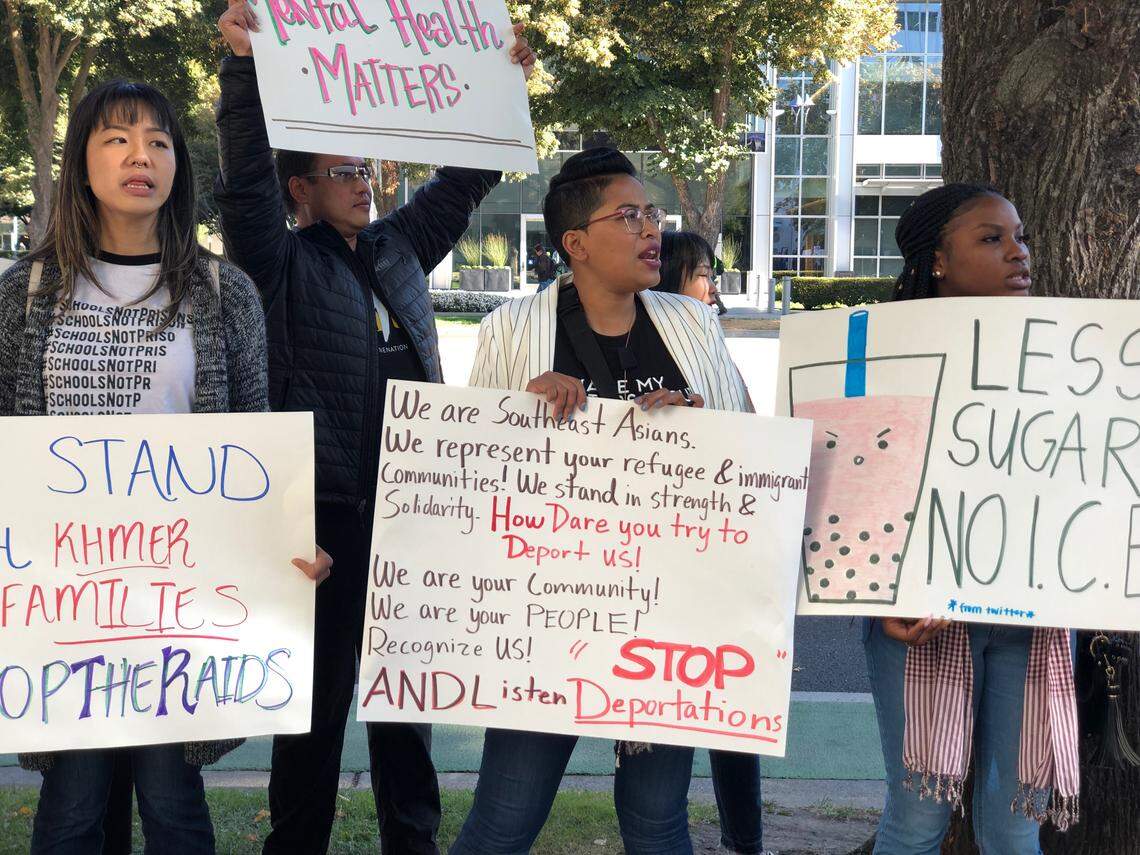 Protesters hold slogans as they rallied against the anticipated deportations of Cambodian Americans on Oct. 3 in Sacramento.
