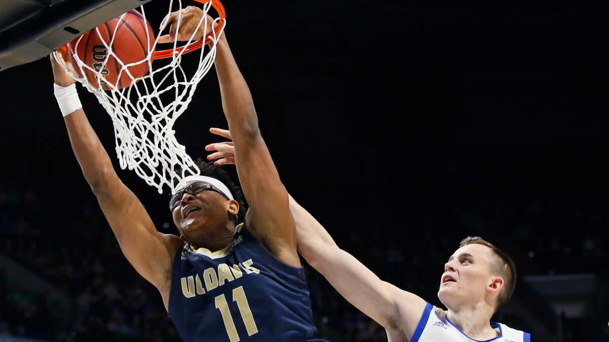 UC Davis forward Chima Moneke (11) dunks in front of Kansas forward Mitch Lightfoot (44) in the second half of a first-round game in the men’s NCAA college basketball tournament in Tulsa, Okla., Friday, March 17, 2017. (AP Photo/Sue Ogrocki)
