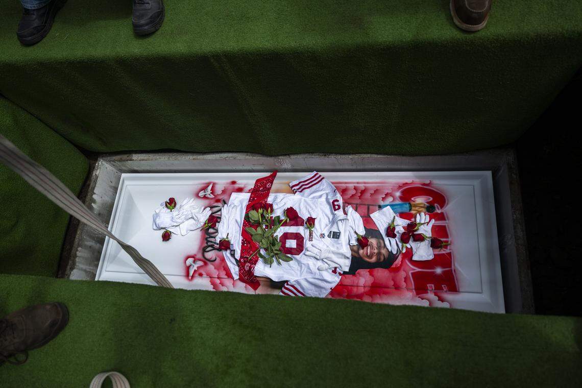 The jersey of former San Francisco 49ers player Deebo Samuels rests on the casket of Jesus Ramos on Monday during his burial at Greenlawn Memorial Park in Colma. Ramos and his brother Jhony were killed in the Esparto fireworks explosion.
