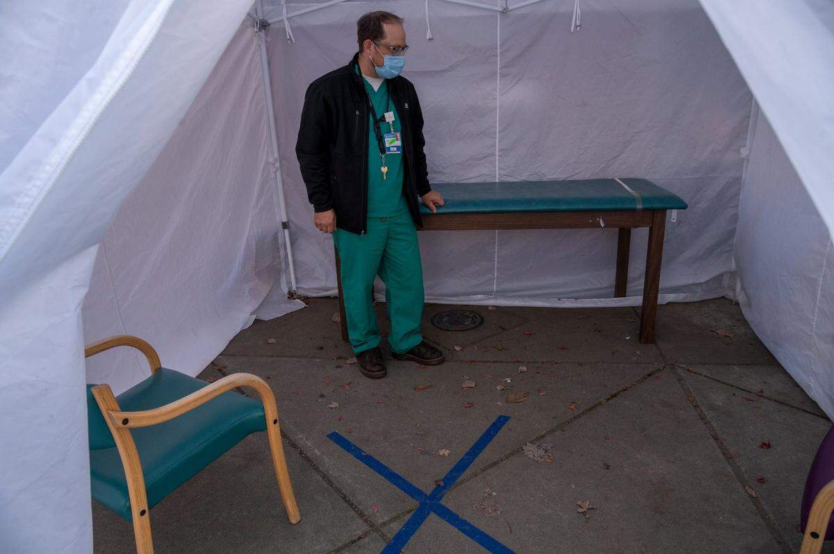 Jonathan Russell, a registered nurse and chief ambulatory officer, stands inside a physical exam tent that is used to exam patients who may have COVID-19, outside of Marshall Medical Center’s clinic in Placerville on Wednesday, Dec. 2, 2020. “This is one of the COVID modifications we had to make recently,” said Russell.
