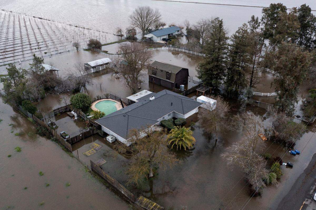 Flooded homes are seen in Point Pleasant on Monday as an evacuation order for residents in Point Pleasant and a shelter-in-place order for those in Wilton remained in effect.