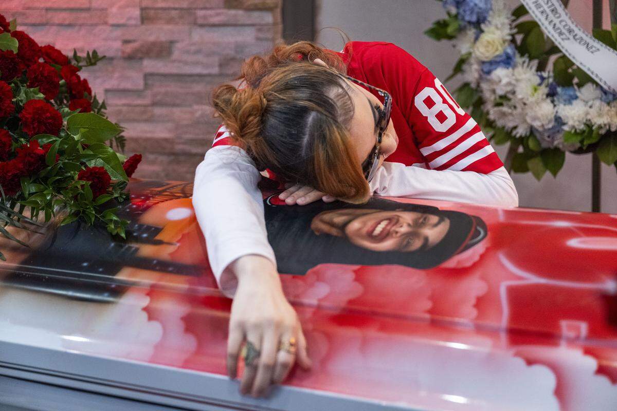 Syanna Ruiz, the girlfriend of Jesus Ramos, leans on his casket during a wake for Ramos and his brother, both victims of the Esparto fireworks explosion, on Sunday, July 27, 2025 in Daly City.