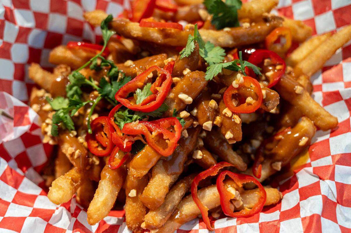 Thai street fries are available from Golden Fry House at the California State Fair on Friday. The french fries are fried in beef tallow and topped with spicy peanut sauce, cilantro and pickled Fresno chiles.