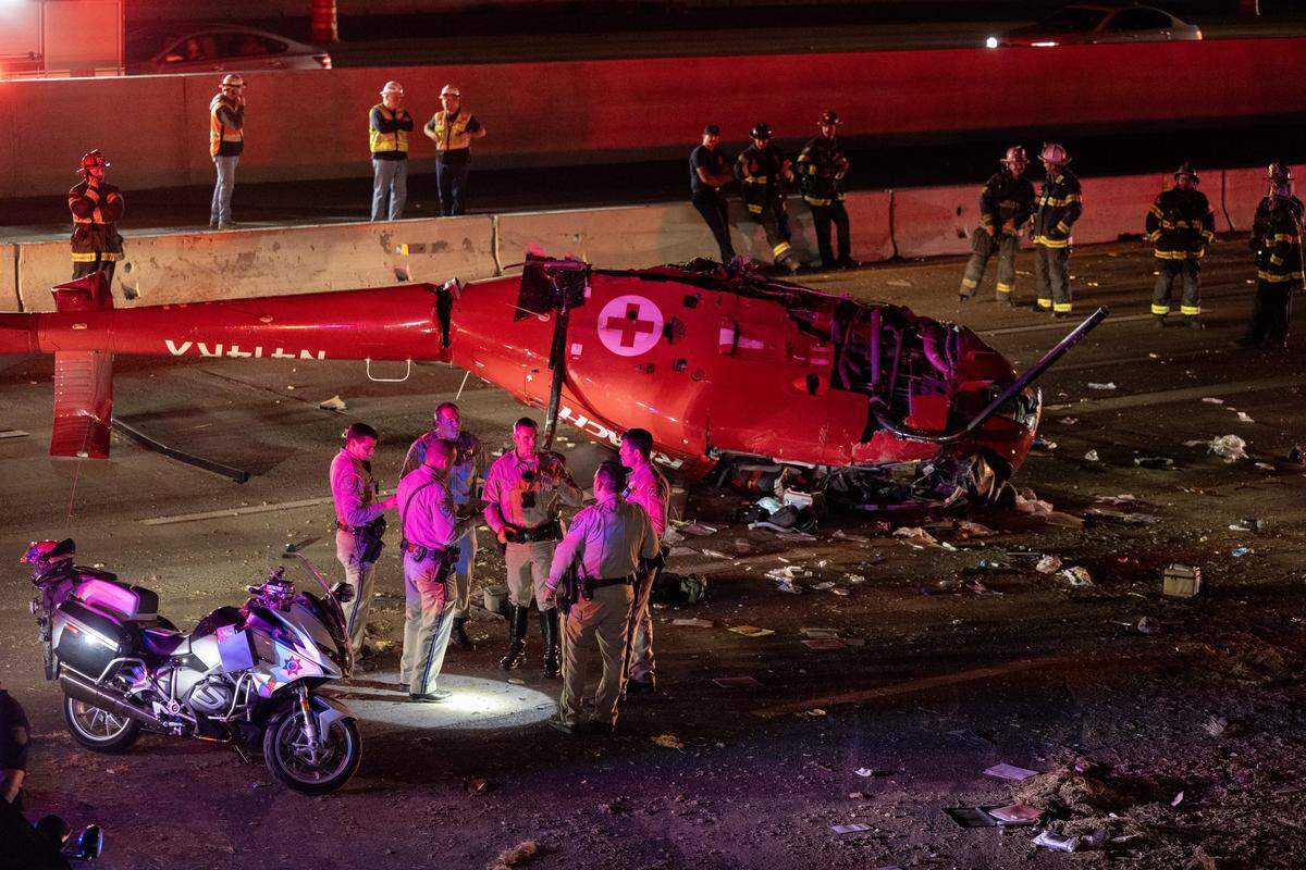 CHP officers and Sacramento firefighters respond to a helicopter that crashed on eastbound Highway 50 near 44th Street in Sacramento on Monday, Oct. 6, 2025.