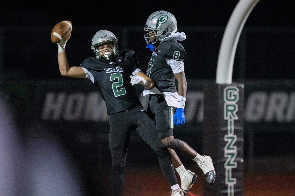 The Granite Bay Grizzlies’ Joseph Cattolico (2) celebrates with Darnell Turner jr. (8) after scoring in the first half of the playoff game on Friday.